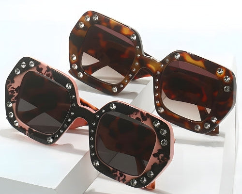 Tortoiseshell sunglasses with rhinestone embellishments on a white background